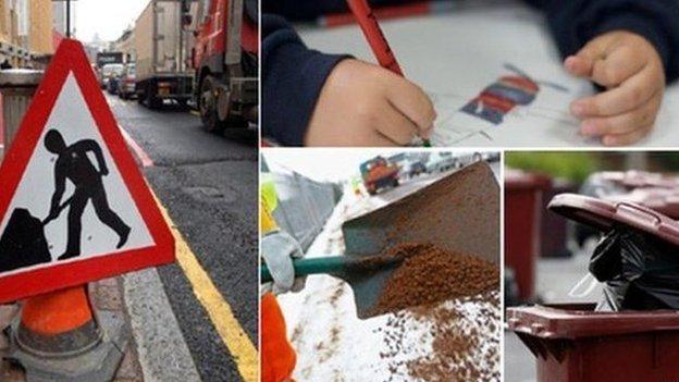 Traffic sign, child writing, road being dug up, and bins waiting to be emptied.