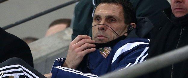 Gus Poyet watches from the stands at Hull