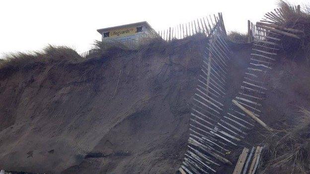 A broken fence shows the extent of storm damage at Whiterocks beach, along Northern Ireland's north coast