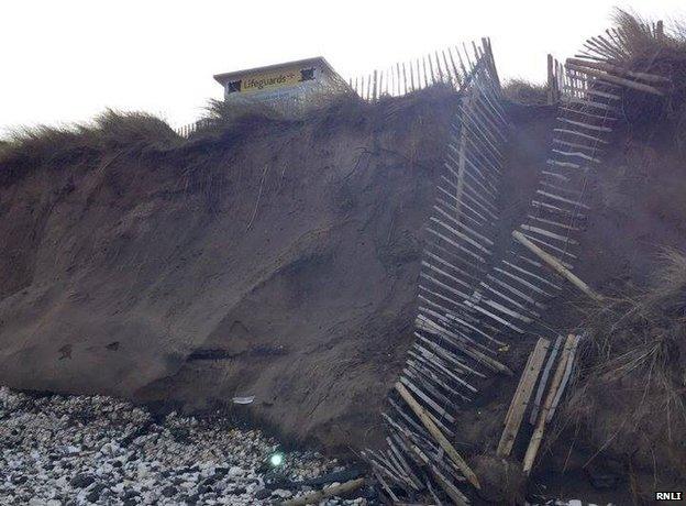 A broken fence shows the extent of storm damage at Whiterocks beach, along Northern Ireland's north coast