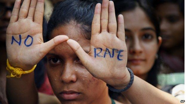 An Indian student displays "NO RAPE" message painted on her hands during a demonstration to demand death sentence for four men convicted of rape and murder of a student on a moving bus in New Delhi bus last year, in Hyderabad, India.