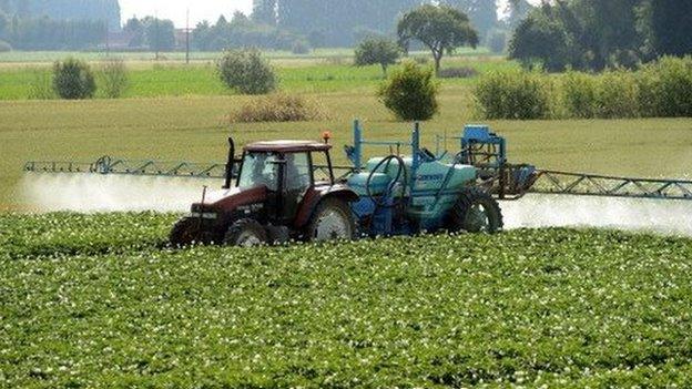 A farmer spreads pesticides on a field in Vimy near Lens, France on 24 June 24 2014