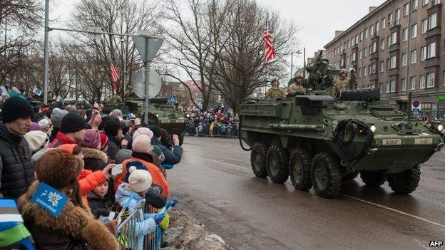 A tank with an US flag takes part in a military parade to celebrate Estonia's independence anniversary in Narva. Photo: 24 February 2015