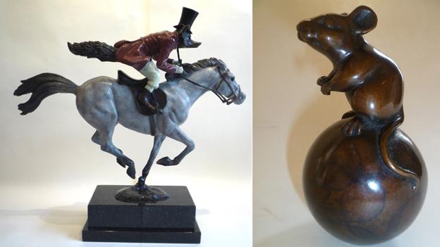 A sculpture of a fox riding a horse and a mouse on a ball