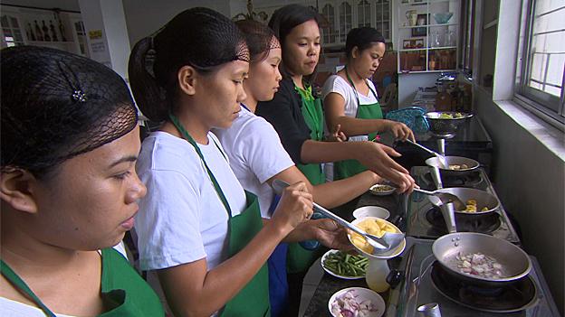 Trainee maids learning to cook