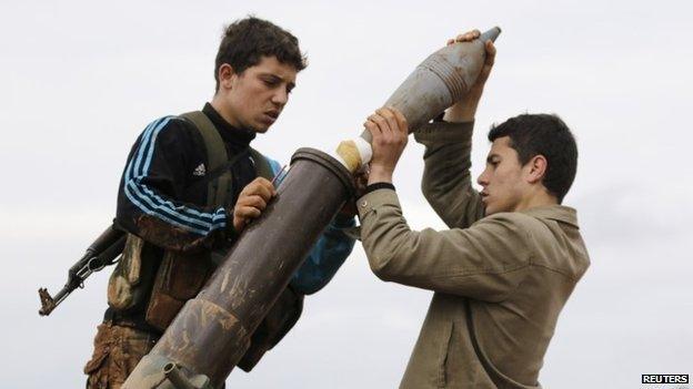 Nusra Front members prepare to fire a mortar towards forces loyal to Syrian President Bashar al-Assad north of Aleppo