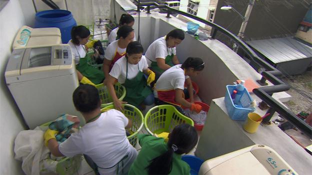 Trainee maids washing clothes