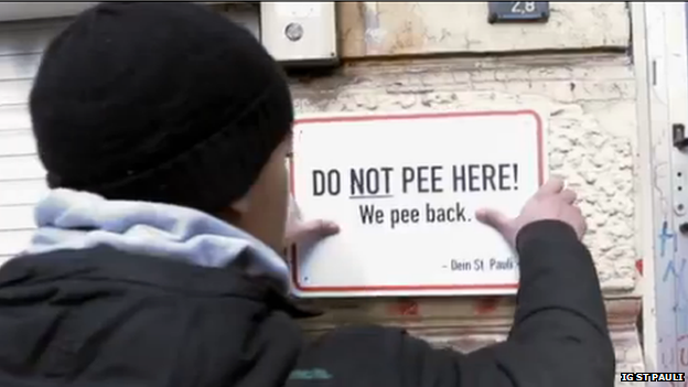 A sign saying "Do not pee here. We pee back."