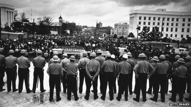 A line of policemen on duty during a black voting rights march in Montgomery, Alabama - 30 MArch 1965