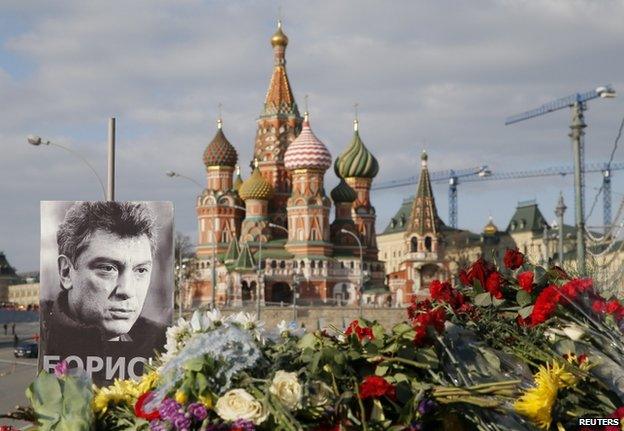 A poster of Boris Nemtsov and flowers at the spot where he was shot in Moscow, 6 March