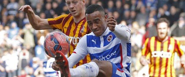 Reading defender Jordan Obita clears under the watch of Bradford striker Jon Stead