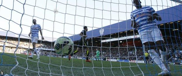 Nedum Onuoha watches the ball hit the back of the net after Tottenham's second goal