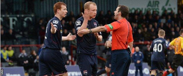 Ross County pair Scott Boyd and Liam Boyce plead with referee Alan Muir to award a penalty