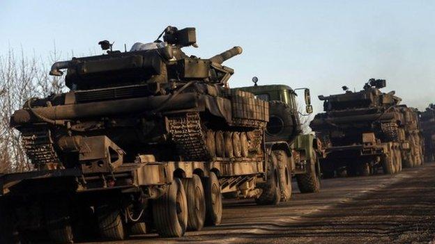 Military trucks from the Ukrainian armed forces transport tanks on the road near Artemivsk, eastern Ukraine, 24 February 2015