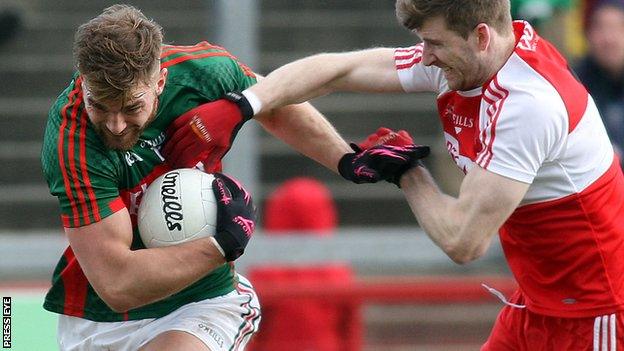 Mayo's Aidan O'Shea attempts to fend off Niall Holly.