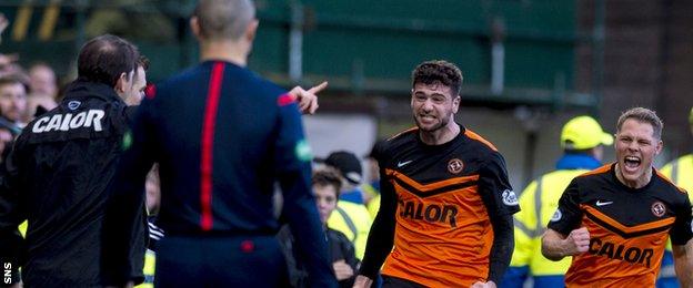 United striker Nadir Ciftci runs towards manager Jackie McNamara after scoring a penalty