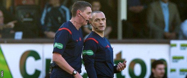 Referee Craig Thomson and assistant Graham Chambers discuss an incident