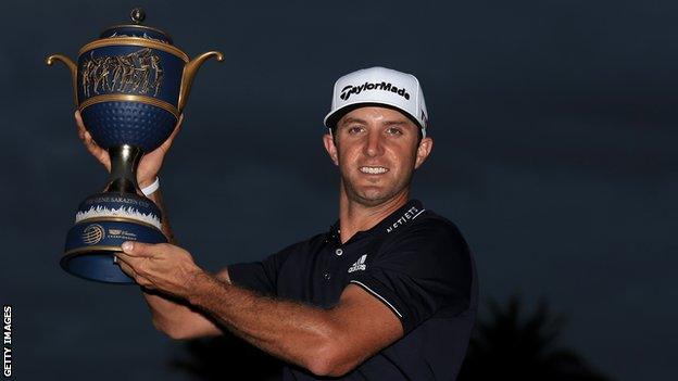 Dustin Johnson lifts the WGC-Cadillac Championship trophy in Miami