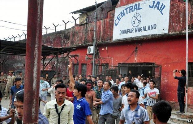 Members of a mob pull a man, centre with blooded face, accused of rape, out of the Central Jail where he was held in Dimapur, in the northeastern Indian state of Nagaland.