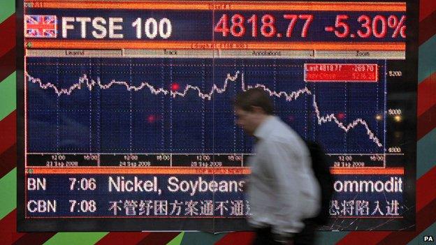 Man walks past FTSE 100 index display, 30 September 2008