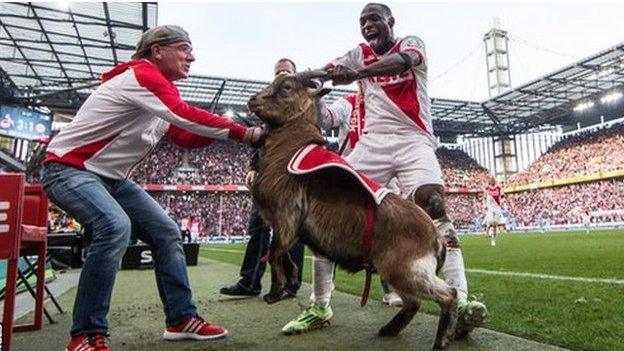 Anthony Ujah (right) and Hennes VIII the goat