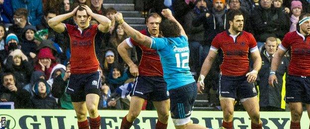 Italy's Enrico Bacchin celebrates at full-time as his side narrowly defeat Scotland 22-19.