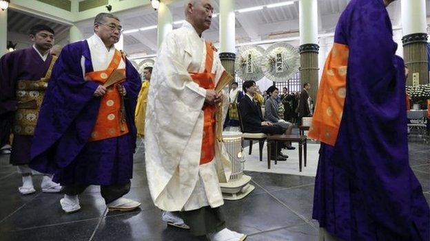 Buddhist priests walk near Japan's Prince Akishino, center left, and Princess Kiko, center right, during Tokyo firebombing memorial service in Tokyo Tuesday, 10 March 2015.