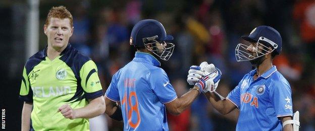 India's Virat Kohli (centre) and Ajinkya Rahane (right) celebrate beating Ireland, next to Kevin O'Brien