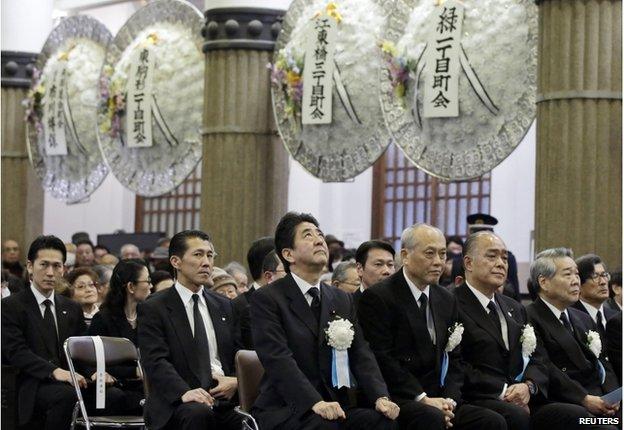 Japan's Prime Minister Shinzo Abe (C) attends the Tokyo firebombing memorial service at Tokyo Memorial Hall in Tokyo 10 March 2015