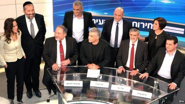 Israeli political party leaders with the an Israeli Channel 2 host (L) posing for a group portrait prior to the taping of the "political duel" or election television debate in the Neve Ilan TV studio