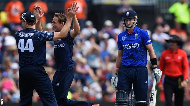 Richie Berrington and Josh Davey celebrate taking the wicket of England's Joe Root