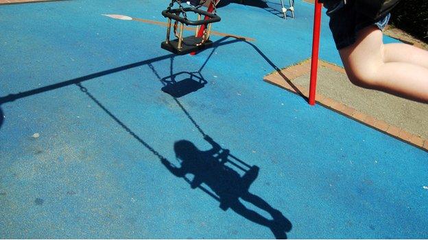 Shadow of child on swing