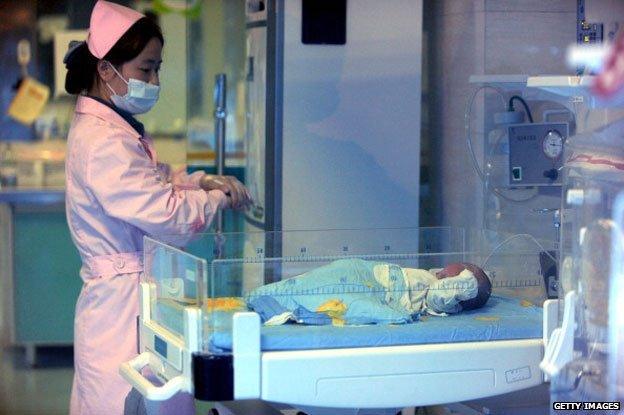 December 18, 2012 shows a nurse looking after a rescued baby in a hospital in Xichang, southwest China's Sichuan province