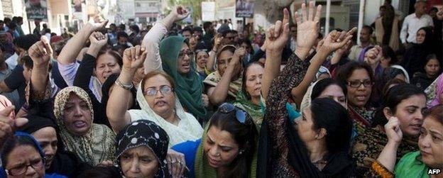 MQM supporters political party shout slogans as they gather outside the MQM headquarters following a raid by paramilitary rangers in Karachi on March 11