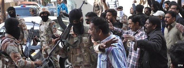 Supporters of MQM clash with Pakistani Rangers during a protest in Karachi, Pakistan, 11 March