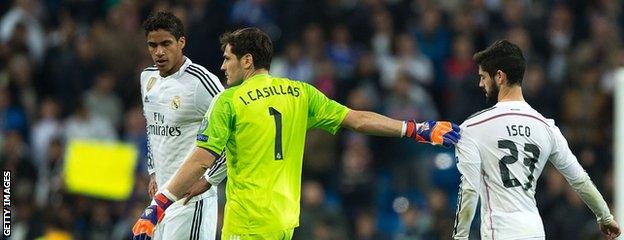 Iker Casillas (centre) drags Isco (right)