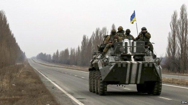 Ukrainian servicemen ride an APC on a road near Donetsk, Ukraine, 02 March 2015