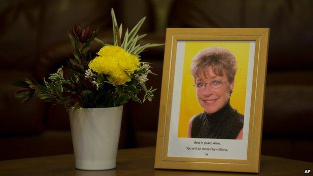 Framed photograph of Anne Kirkbride next to flowers