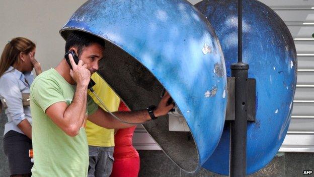 A Cuban talks by phone in a street of Havana on March 11, 2015.