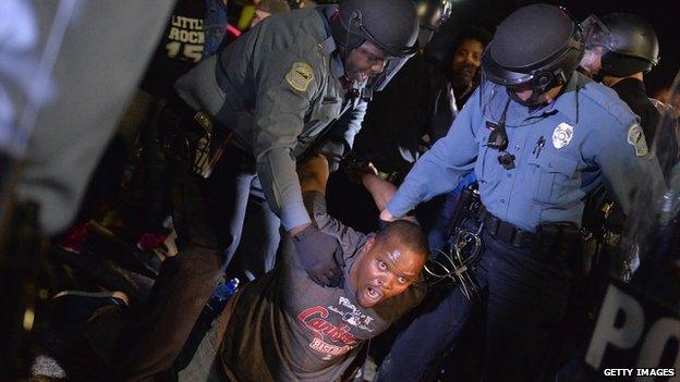 A demonstrator is detained and arrested during a protest outside the Ferguson Police Department on March11, 2015