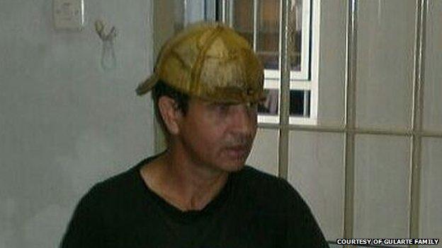 Rodrigo Gularte in his prison cell, wearing a baseball cap