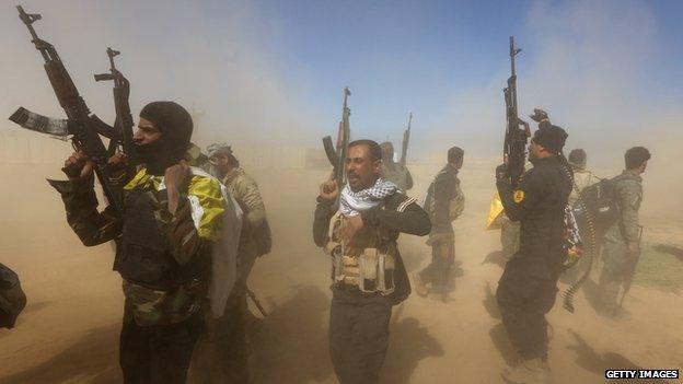 Iraqi fighters of the government-controlled Popular Mobilisation units gather on the western entrance of the Iraqi city of Tikrit during a military operation to take control of the city