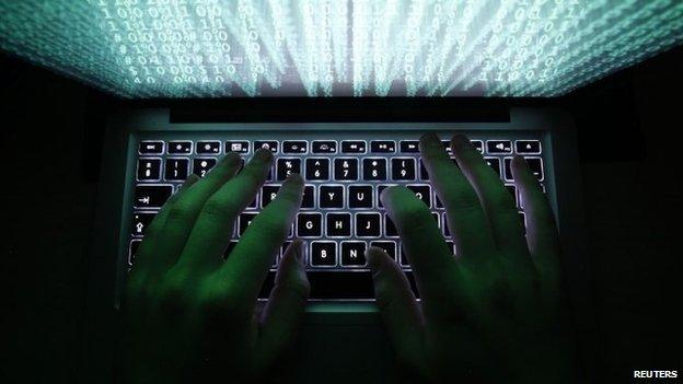 Person typing on a computer keyboard