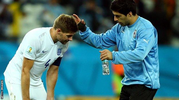 Luis Suarez comforts England's Steven Gerrard