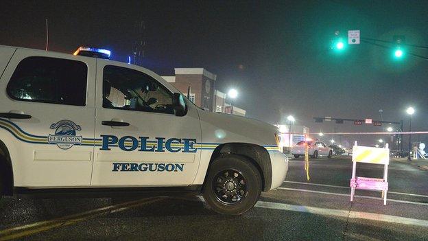 Police block off an area in Ferguson after two officers were shot.