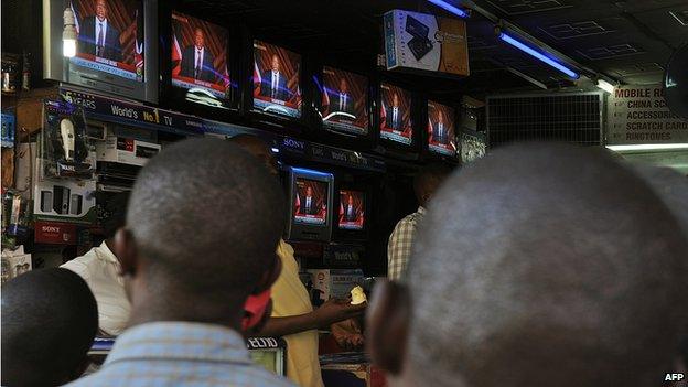 People watch on television sets in a shop in Nairobi Uhuru Kenyatta's speech after he was declared winner of a presidential election in Kenya - March 2013