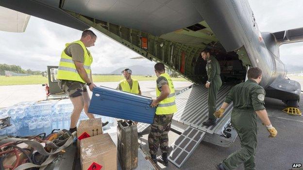 Privates load water bottles and other relief into a French Army logistical transport plane bound for Vanuatu, at the Aerial Military Base Lieutenant Paul Klein (formerly known as La Tontouta), north of Noumea, New Caledonia, on 15 March 2015