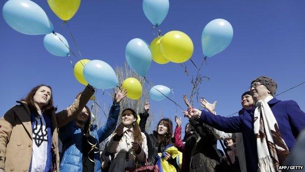 People release balloons in the colours of the Ukrainian flag during a rally marking the anniversary of Ukrainian poet Taras Shevchenko 1814-1861, in Simferopol, on 9 March 2015