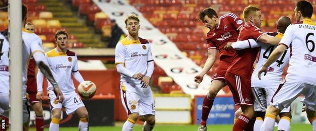 Ash Taylor heads for goal