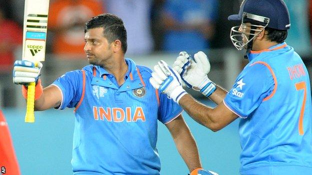 Suresh Raina celebrates reaching his century against Zimbabwe